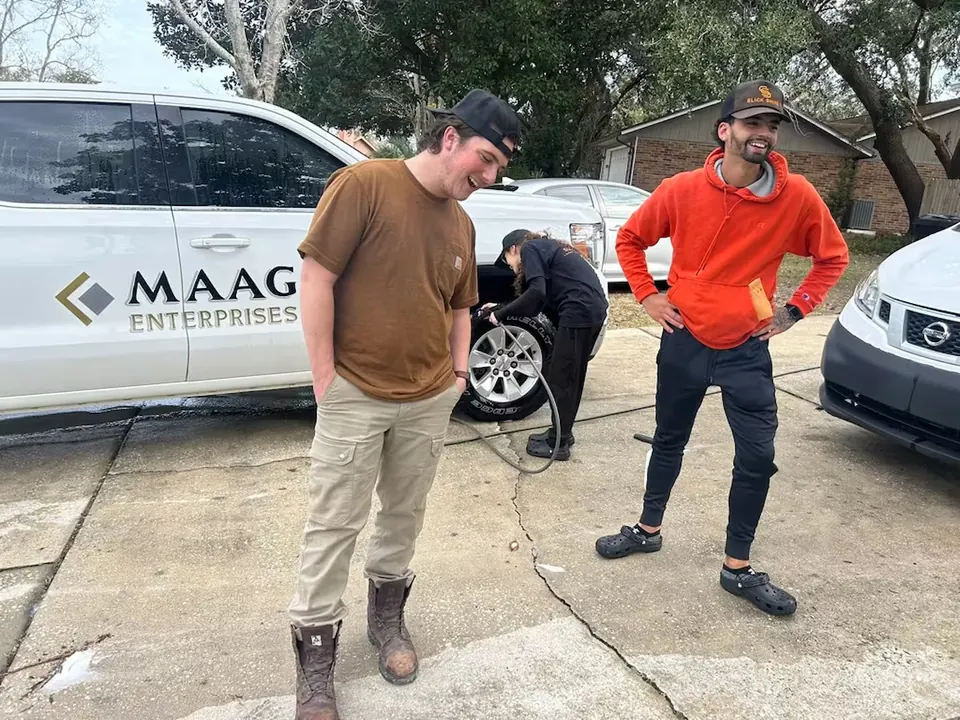 Chris and Ricky beside a work van during a mobile detail
